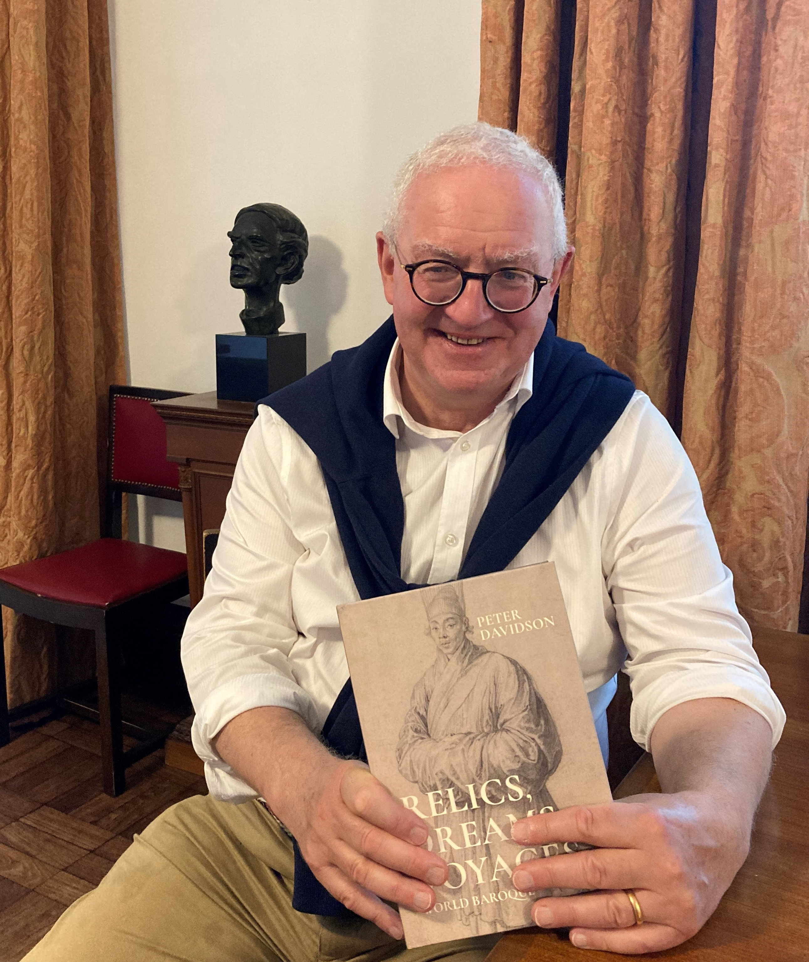 Prof Peter Davidson holding his new book Relics, Dreams, Voyages: world baroque 