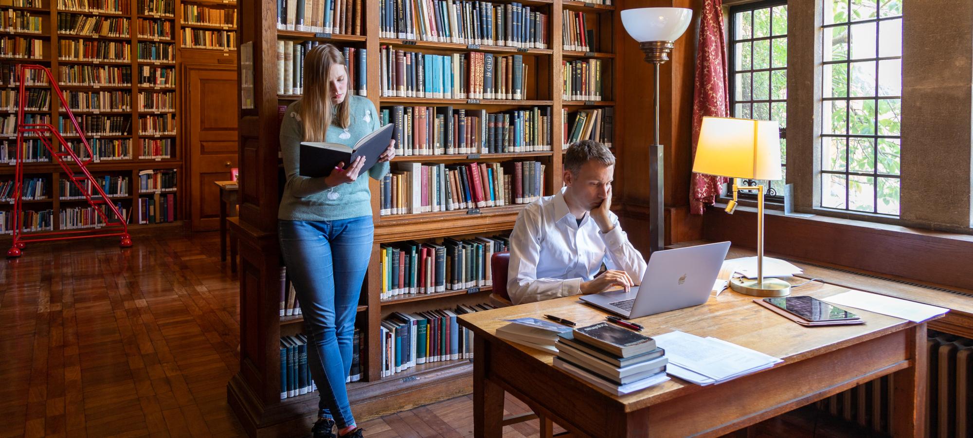 Campion Hall Library where two students are studying
