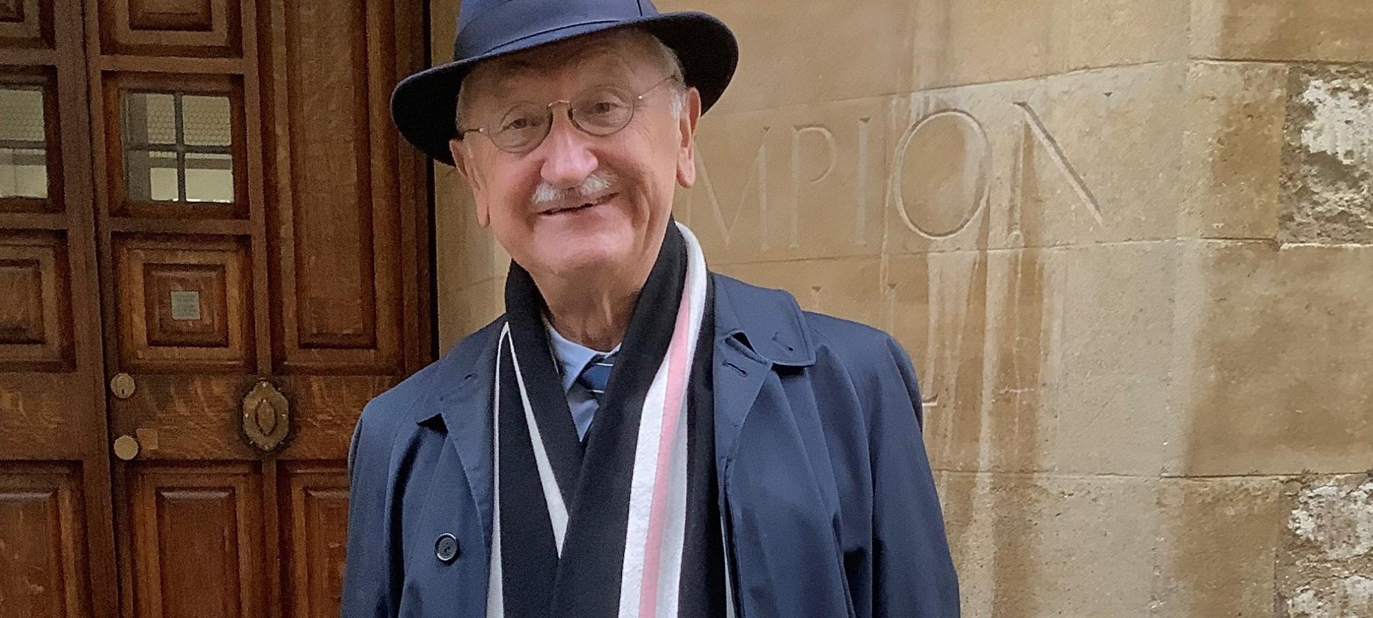 Photograph shows man wearing college scarf