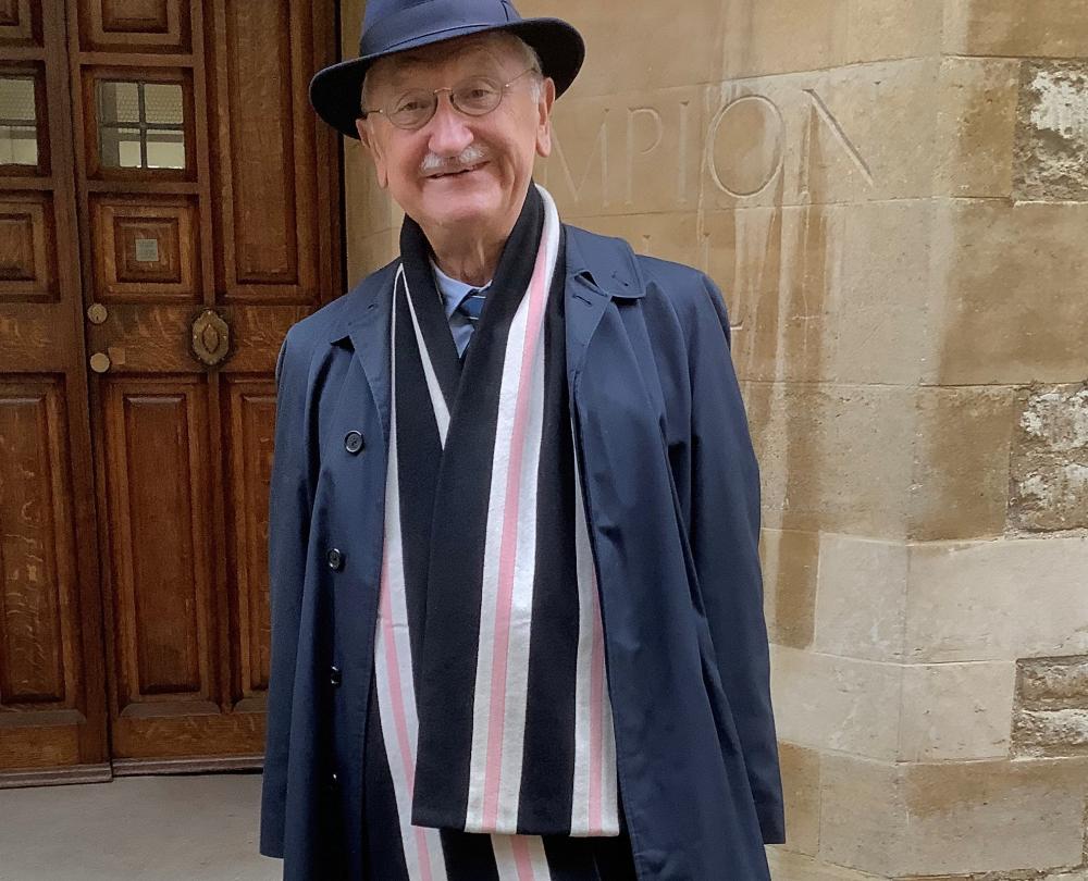 Photograph shows man wearing college scarf